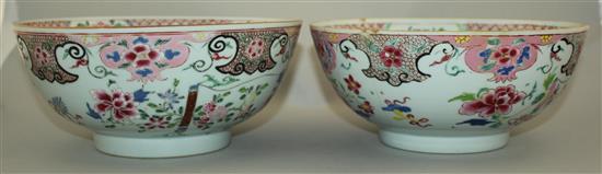 A pair of Chinese famille rose bowls, Qianlong period, 23.3cm, some faults, wood stands